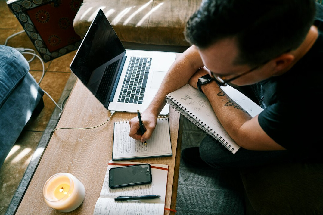 writer at desk with notebook